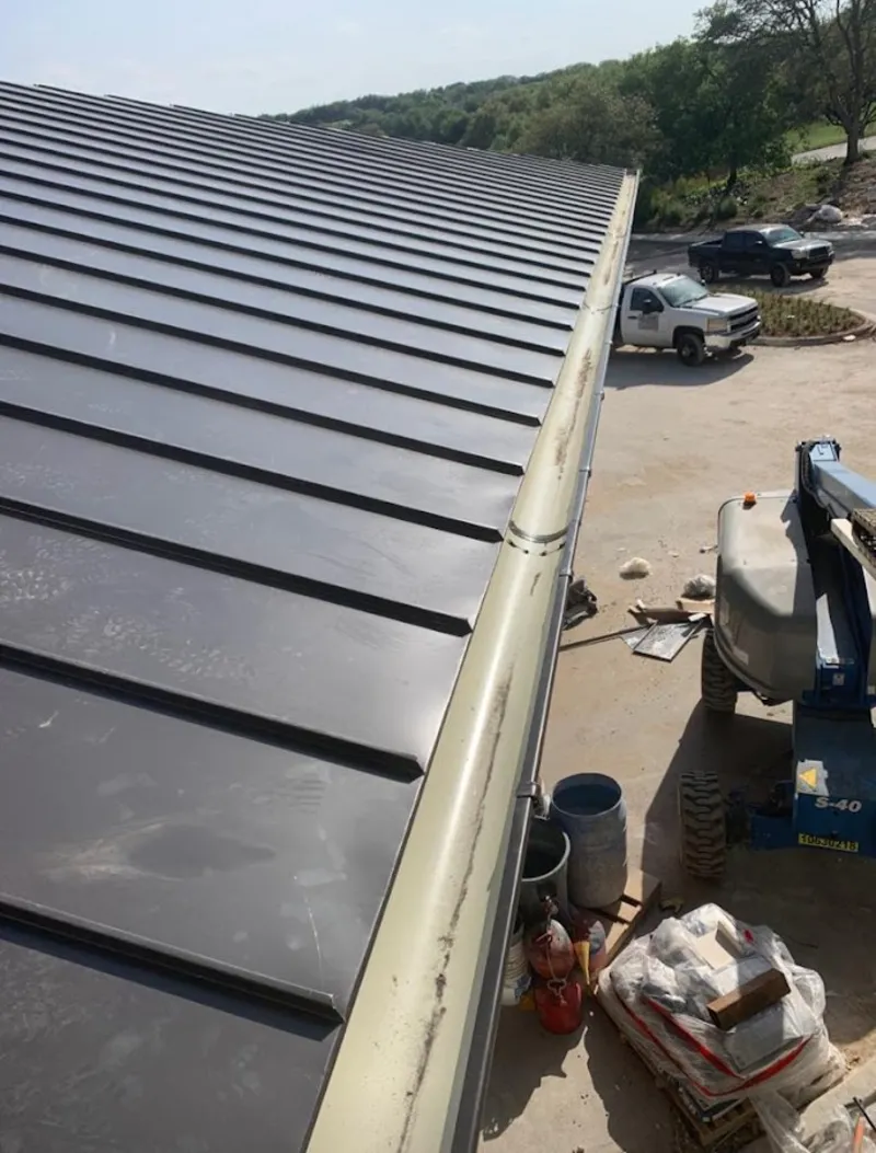 Standing seam panel and gutter detail on a metal roofing jobsite in Mount Joy